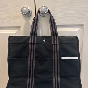 Authentic Hermes Herline canvas tote in blue/gray with classic striped handles.